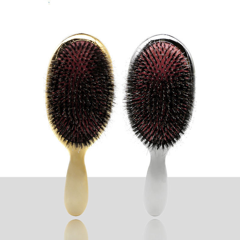 Gold and silver wild boar bristle air cushion paddle hair brushes with ergonomic handles for detangling, smoothing, scalp massage and everyday hair care.