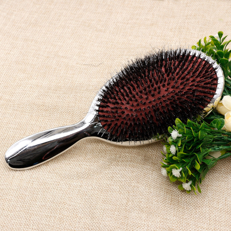 Wild boar bristle air cushion paddle hairbrush with dense black bristles, red cushioned base and polished silver ergonomic handle for detangling, smoothing, frizz control, scalp massage, shine enhancement and everyday hair care.