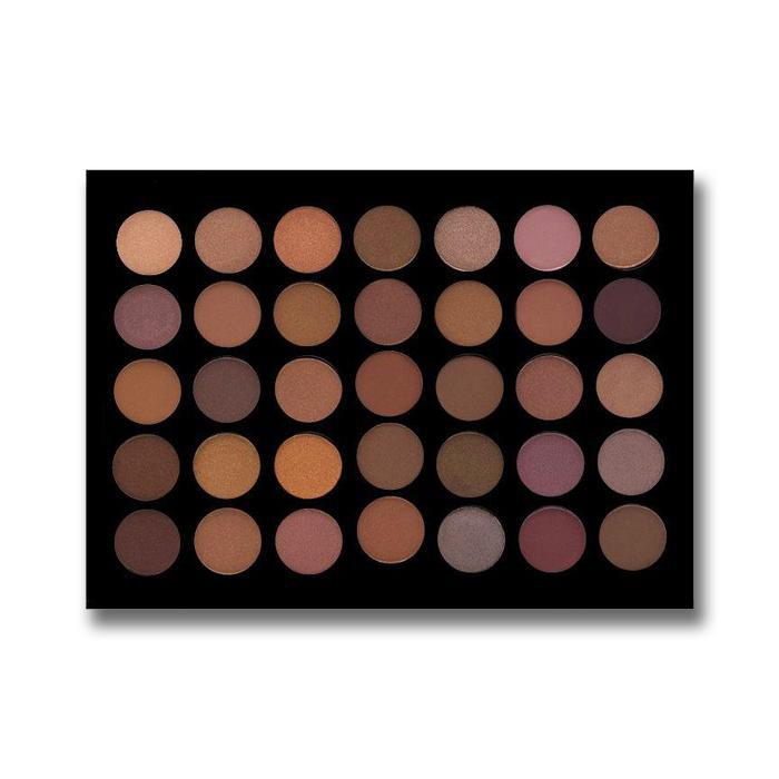 A rectangular eyeshadow palette with 24 circular pans of makeup in warm neutral and pinkish shades, set against a plain white background.