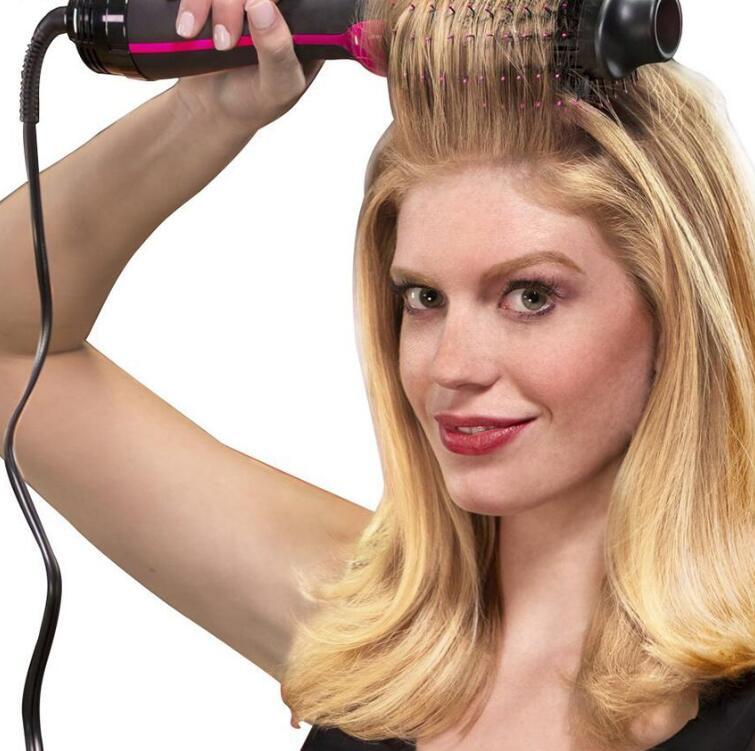 Woman using a One-Step Electric Hot Air Brush Hair Dryer to dry, volumize, smooth and style blonde hair for a salon-quality blowout at home