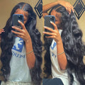 Long black wavy lace front wig with deep side part, natural-looking hairline, baby hairs and voluminous body waves in extra-long length.