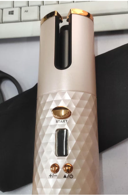 White and rose gold wireless automatic electric hair curler with rotating ceramic curling barrel, digital controls, start button and cordless rechargeable design; portable curling iron for creating defined curls, loose waves and salon-style hairstyles at home or while traveling.