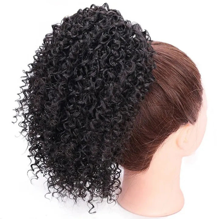 African drawstring small curly ponytail wig extension for Black women, natural black kinky curly hairpiece with voluminous defined curls, adjustable drawstring attachment, protective updo and natural-textured curly puff hairstyle.