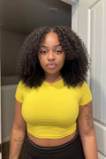 Woman wearing a yellow shirt in an indoor setting Afro Kinky Curly 100% Human Hair Glueless Wig 5x5 Bleached Knots Wear Go Wig Pre Cut HD Lace Front Wig