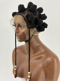 Mannequin head with a wig featuring braided hair and decorative elements on a white background