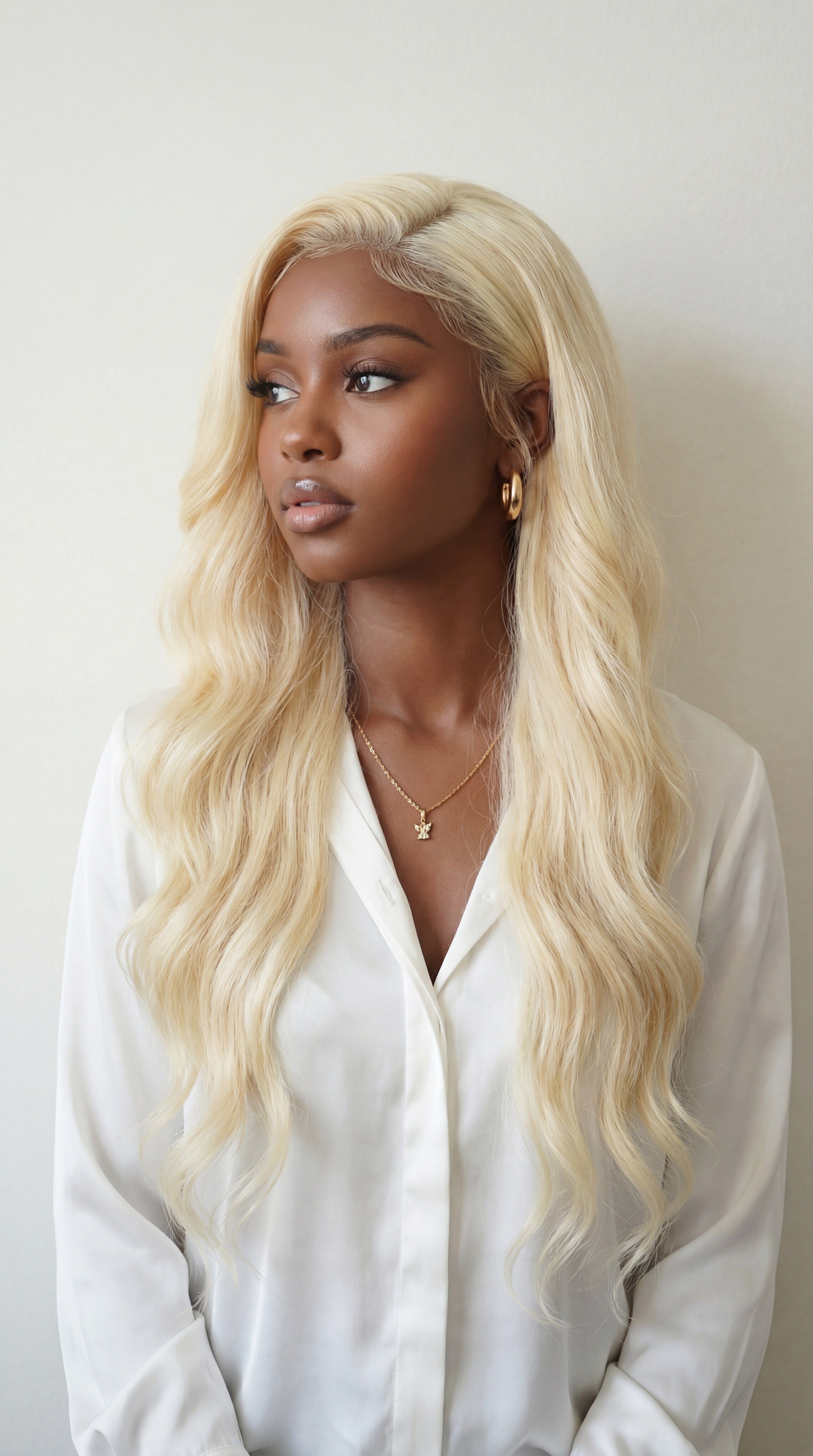 Woman with long blonde hair wearing a white shirt against a plain background Blonde 613 Virgin 100% Human Hair 5x5 Closure or 13x4 Adjustable Glueless Lace Frontal Wig