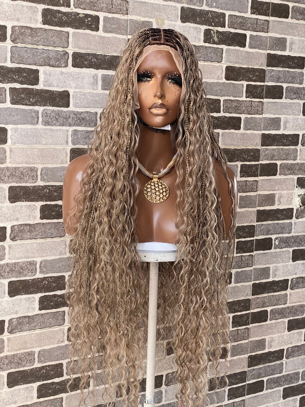 Mannequin head with long wavy brown wig against a brick wall background. Bohemian Knotles custom color Full lace wig (Mix color)