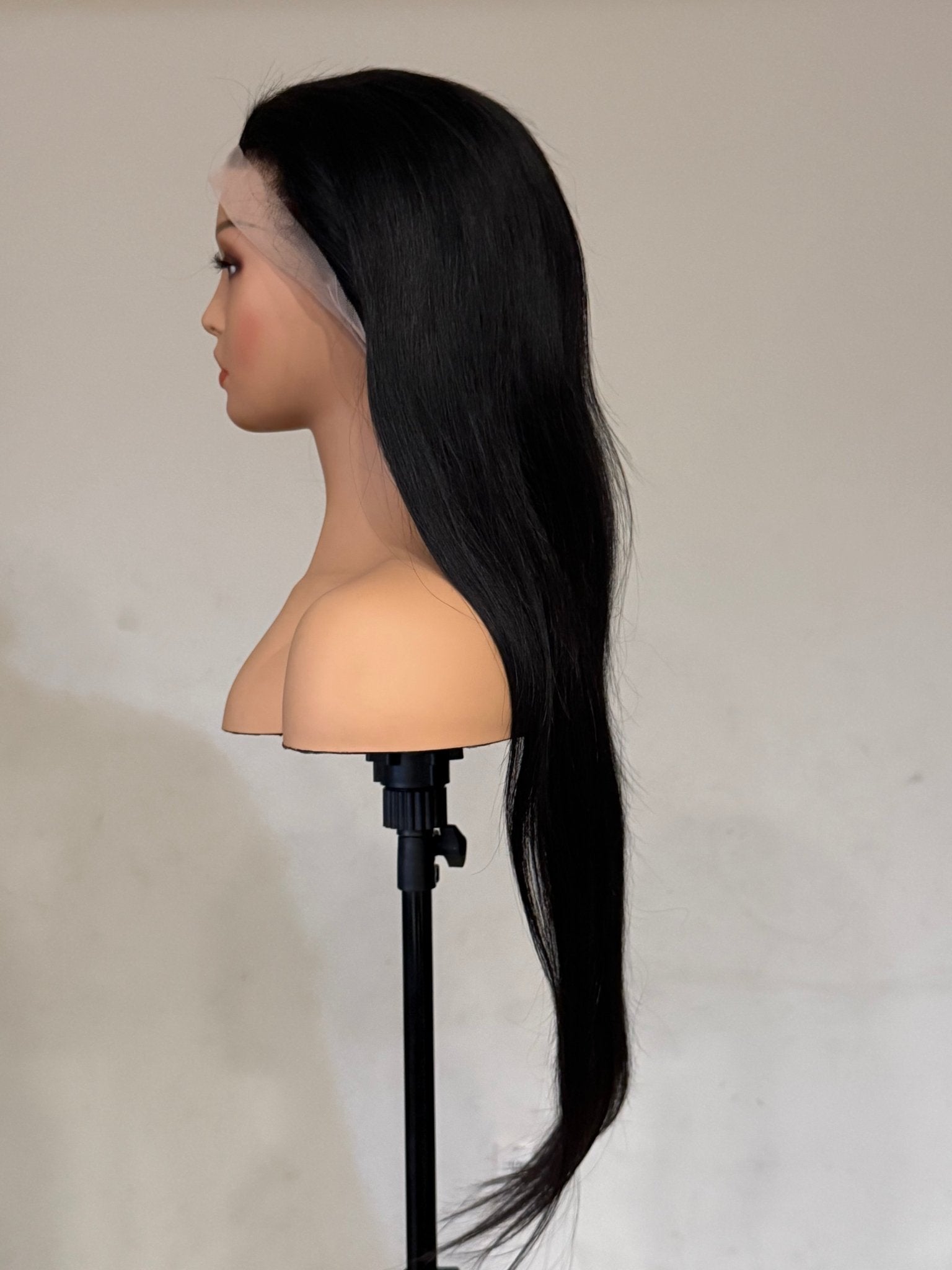 Black wig on a mannequin head against a plain background brazilian straight wig, brazilian straight lace front wig, straight lace front wig, straight human hair wig, natural black wig, black lace front wig, human hair wig, 100% human hair wig, glueless wig, ready to wear wig, natural hairline wig, realistic lace front wig, premium human hair wig, luxury wig, long straight wig, long black wig, heat safe wig, everyday wig, date night wig, photo ready wig