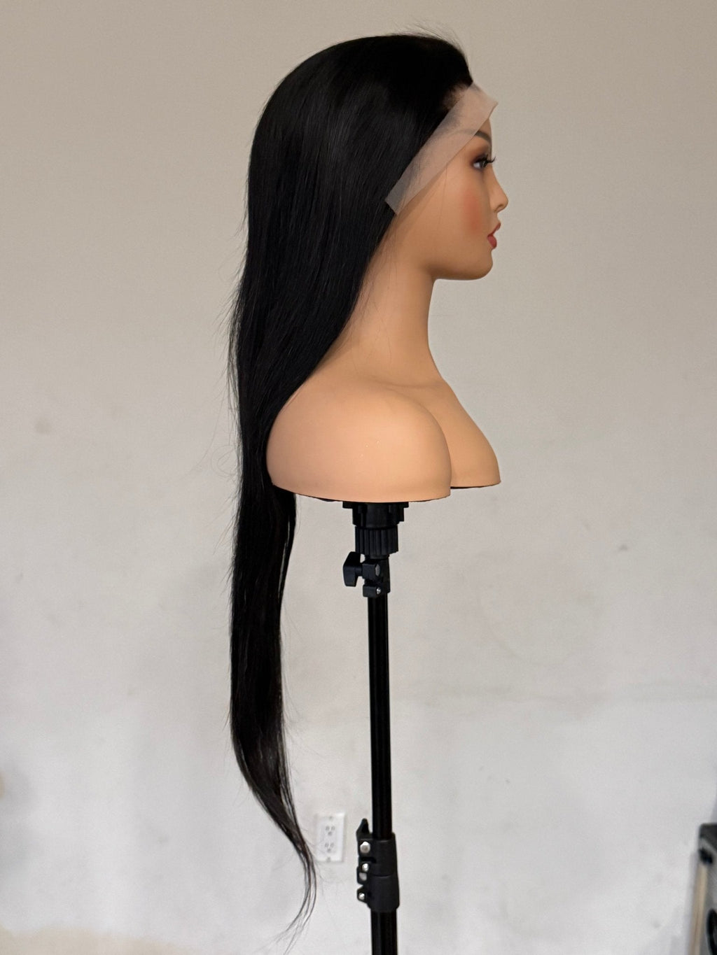 Black wig on a mannequin head with a white background brazilian straight wig, brazilian straight lace front wig, straight lace front wig, straight human hair wig, natural black wig, black lace front wig, human hair wig, 100% human hair wig, glueless wig, ready to wear wig, natural hairline wig, realistic lace front wig, premium human hair wig, luxury wig, long straight wig, long black wig, heat safe wig, everyday wig, date night wig, photo ready wig