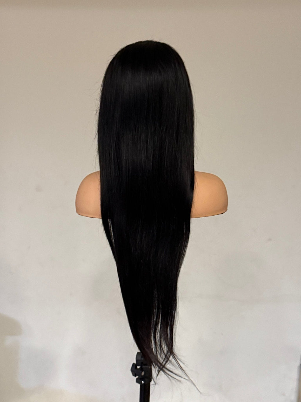 Mannequin head with long black straight hair on a plain background brazilian straight wig, brazilian straight lace front wig, straight lace front wig, straight human hair wig, natural black wig, black lace front wig, human hair wig, 100% human hair wig, glueless wig, ready to wear wig, natural hairline wig, realistic lace front wig, premium human hair wig, luxury wig, long straight wig, long black wig, heat safe wig, everyday wig, date night wig, photo ready wig