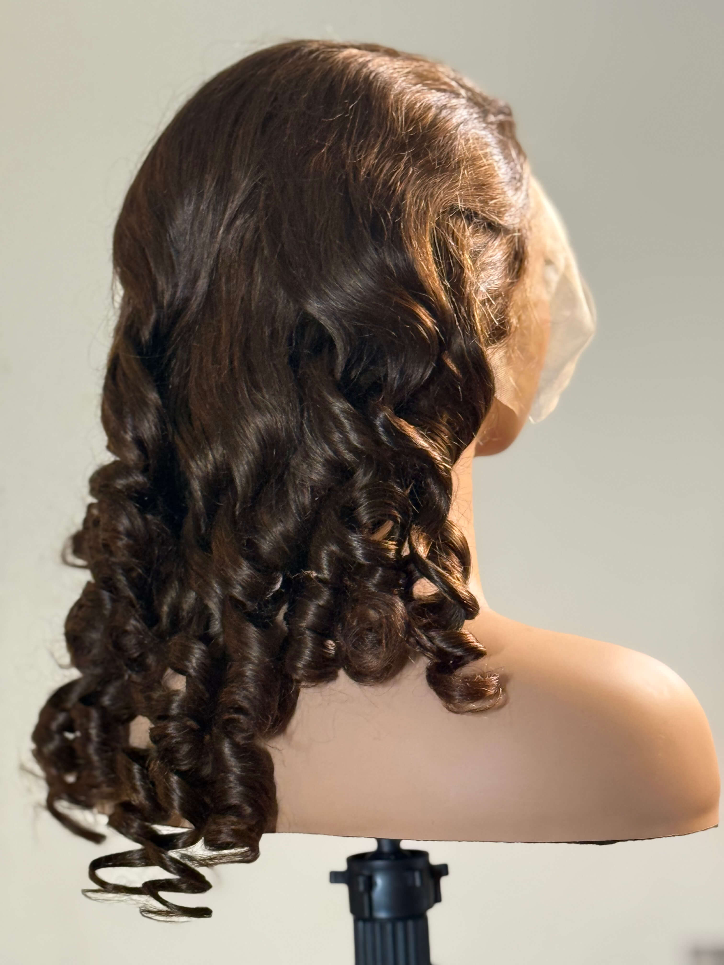 Brown wig on a mannequin head against a plain background brown sugar bounce, chocolate brown lace front wig, chocolate brown human hair wig, brown lace front wig, brown human hair wig, brunette wig, brunette lace front wig, chocolate wig, rich brown wig, mocha brown wig, caramel brown wig, warm brown wig, chocolate brown hair wig, long loose wave wig, loose wave human hair wig, loose wave lace wig, luxury brown wig, premium human hair wig, natural part wig, realistic lace front wig, seamless hairline wig, m