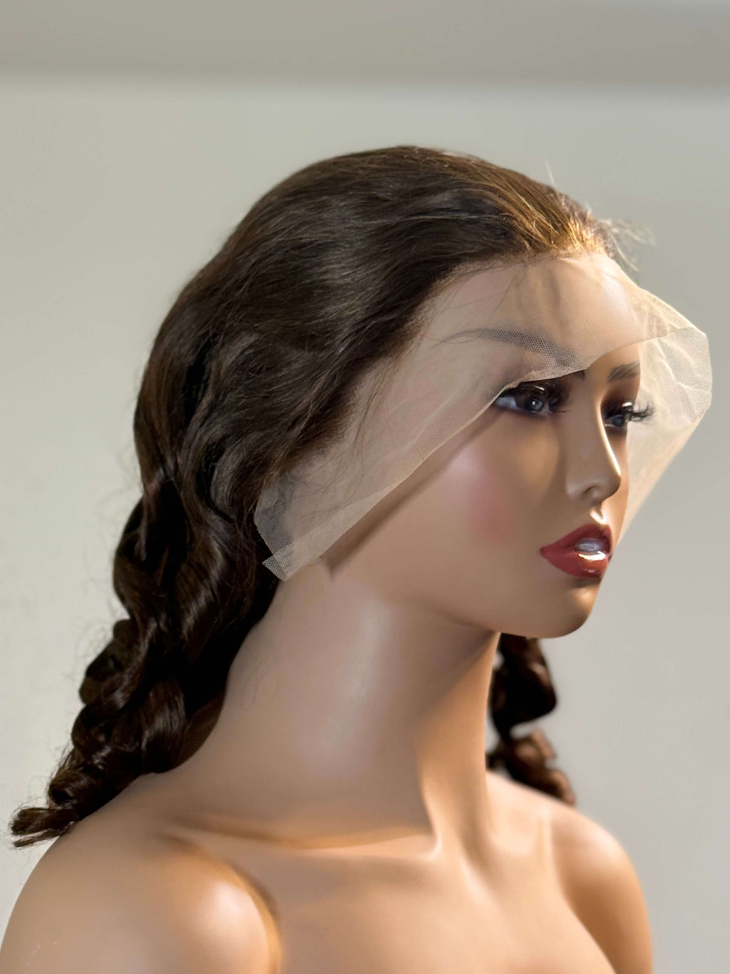 Mannequin head with a dark brown wig and a white veil on a plain background brown sugar bounce, chocolate brown lace front wig, chocolate brown human hair wig, brown lace front wig, brown human hair wig, brunette wig, brunette lace front wig, chocolate wig, rich brown wig, mocha brown wig, caramel brown wig, warm brown wig, chocolate brown hair wig, long loose wave wig, loose wave human hair wig, loose wave lace wig, luxury brown wig, premium human hair wig, natural part wig, realistic lace front wig, seaml
