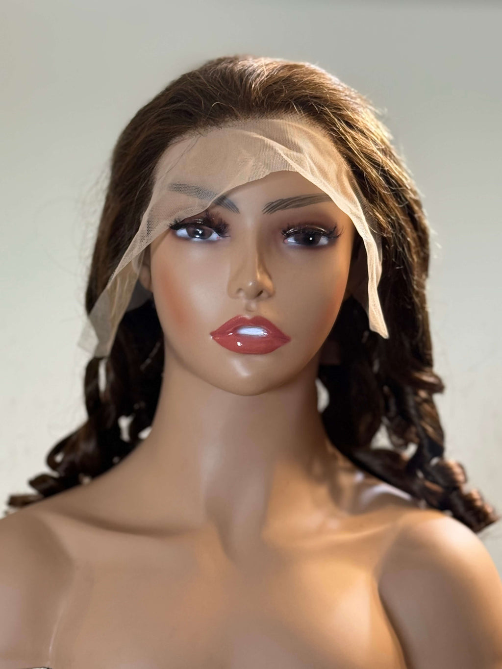 Mannequin head with a brown wig and white mesh veil on a plain background brown sugar bounce, chocolate brown lace front wig, chocolate brown human hair wig, brown lace front wig, brown human hair wig, brunette wig, brunette lace front wig, chocolate wig, rich brown wig, mocha brown wig, caramel brown wig, warm brown wig, chocolate brown hair wig, long loose wave wig, loose wave human hair wig, loose wave lace wig, luxury brown wig, premium human hair wig, natural part wig, realistic lace front wig, seamles