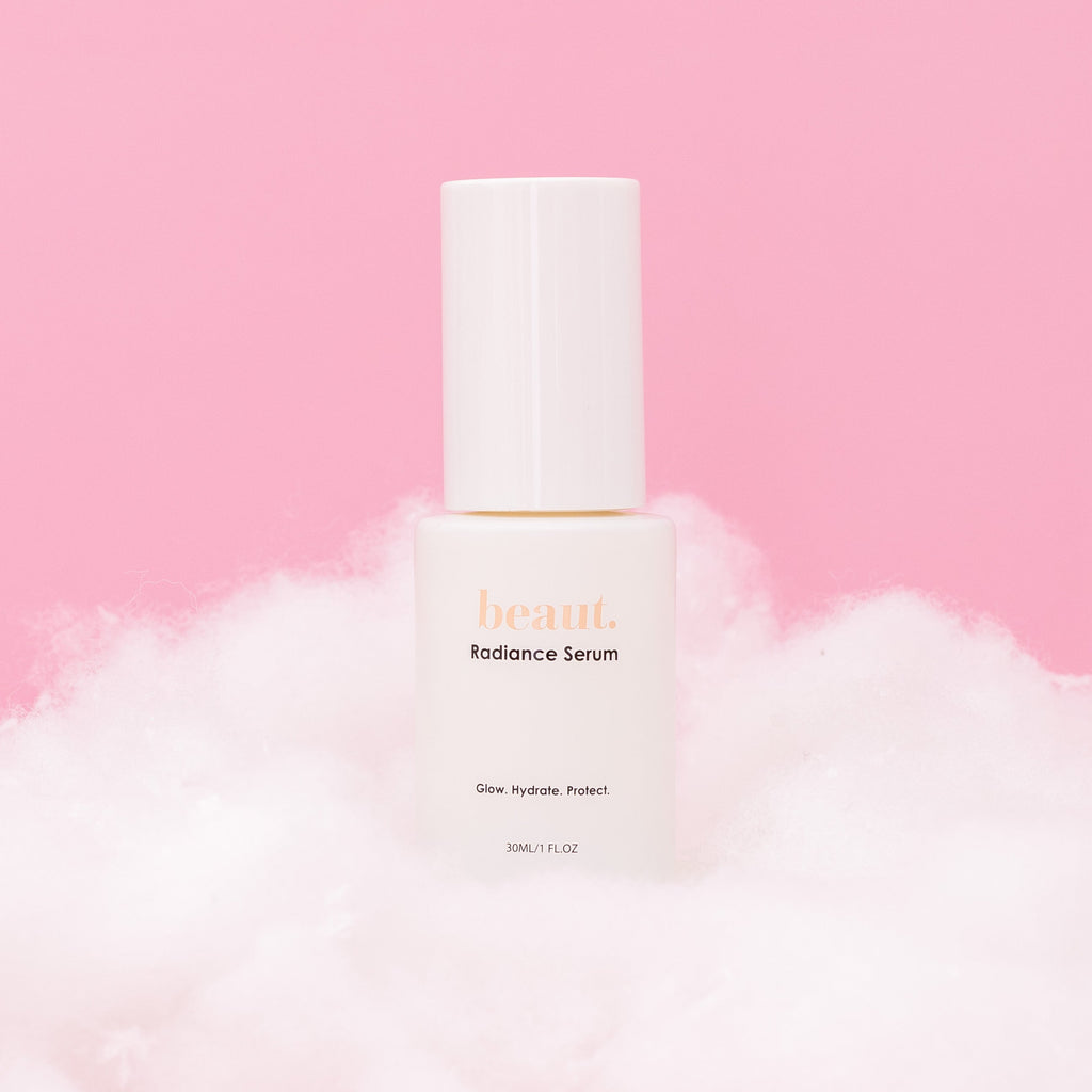 Beaut Radiance Serum hydrating facial skincare serum for glowing radiant skin, lightweight face serum bottle on soft pink cloud background