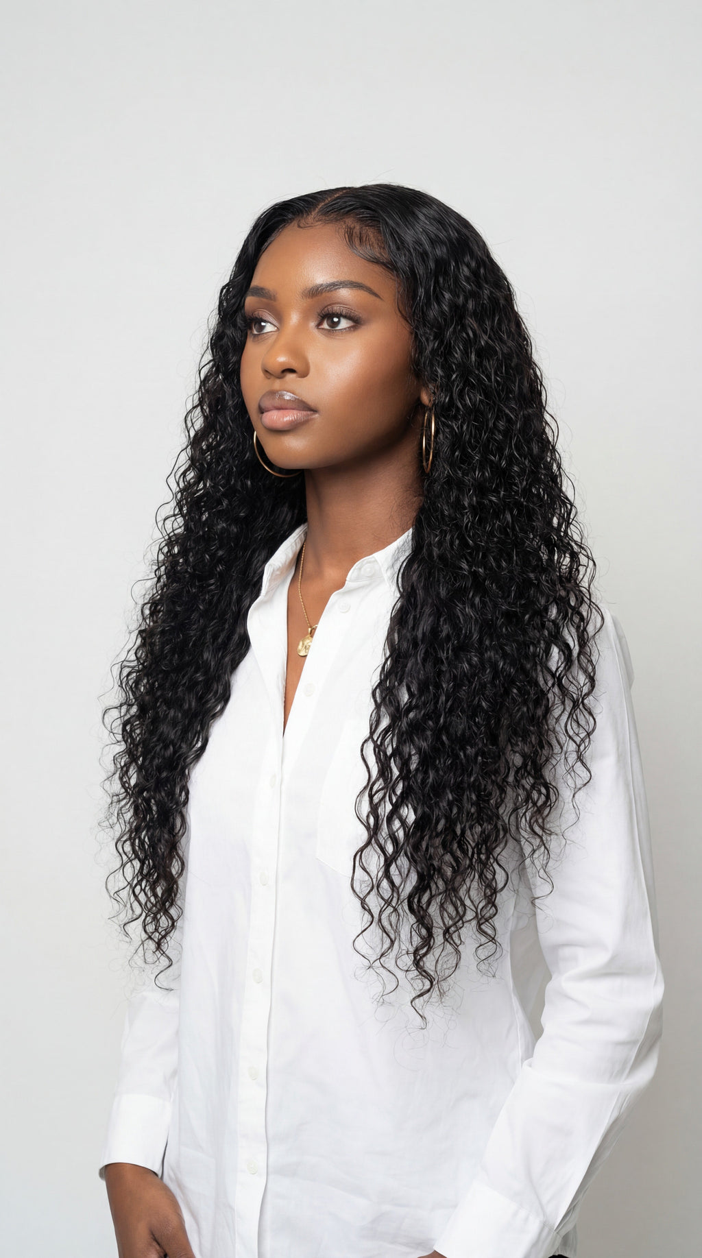 Woman with long, curly hair wearing a white shirt against a plain background Italian Curl Virgin Hair Wig - Made with 100% Virgin Human Hair