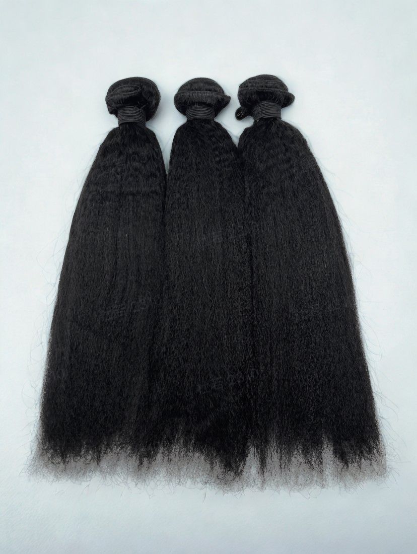 Three bundles of black hair extensions on a white background