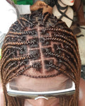 Person with braided hair using a flat iron, with a blurred background. Knotless Braid Wig,  100% Human Hair Dark Honey Blond, Swiss Full Lace, Glueless - Helen