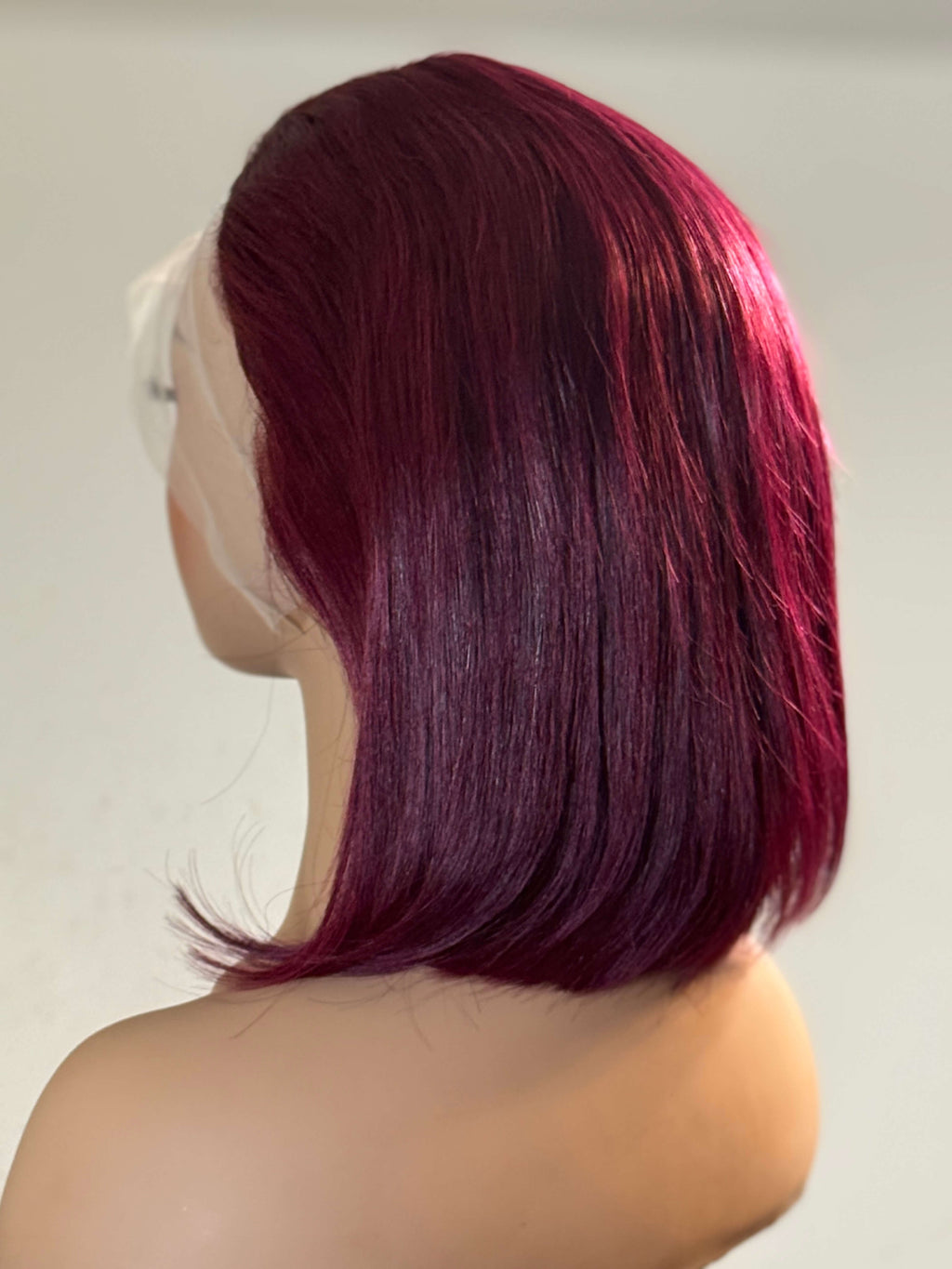 Mannequin head with red hair styled in a bob against a plain background. burgundy wig, burgundy red wig, burgundy lace front wig, burgundy human hair wig, wine red wig, wine color wig, red lace front wig, red human hair wig, red bob wig, burgundy bob wig, burgundy lace wig, burgundy human hair bob wig, straight bob wig, straight lace front wig, straight human hair wig, human hair bob wig, lace front bob wig, bob lace wig, chic bob wig, sleek bob wig, short human hair wig, short lace front wig, short bob wig