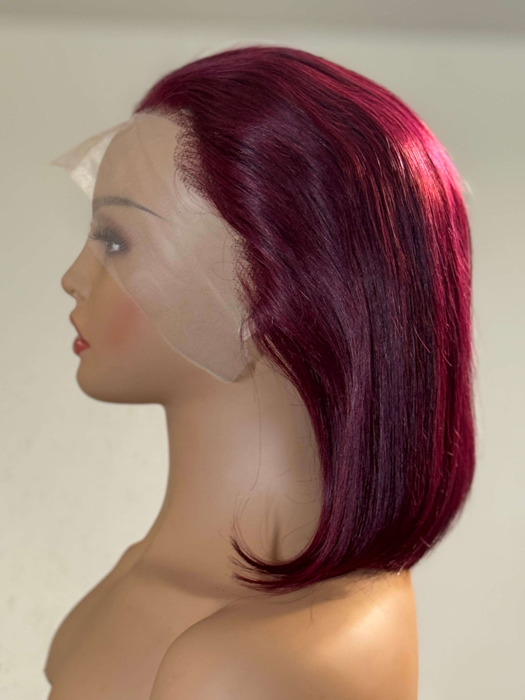 Mannequin head with a burgundy wig on a plain background. burgundy wig, burgundy red wig, burgundy lace front wig, burgundy human hair wig, wine red wig, wine color wig, red lace front wig, red human hair wig, red bob wig, burgundy bob wig, burgundy lace wig, burgundy human hair bob wig, straight bob wig, straight lace front wig, straight human hair wig, human hair bob wig, lace front bob wig, bob lace wig, chic bob wig, sleek bob wig, short human hair wig, short lace front wig, short wig, bob hairstyle wig