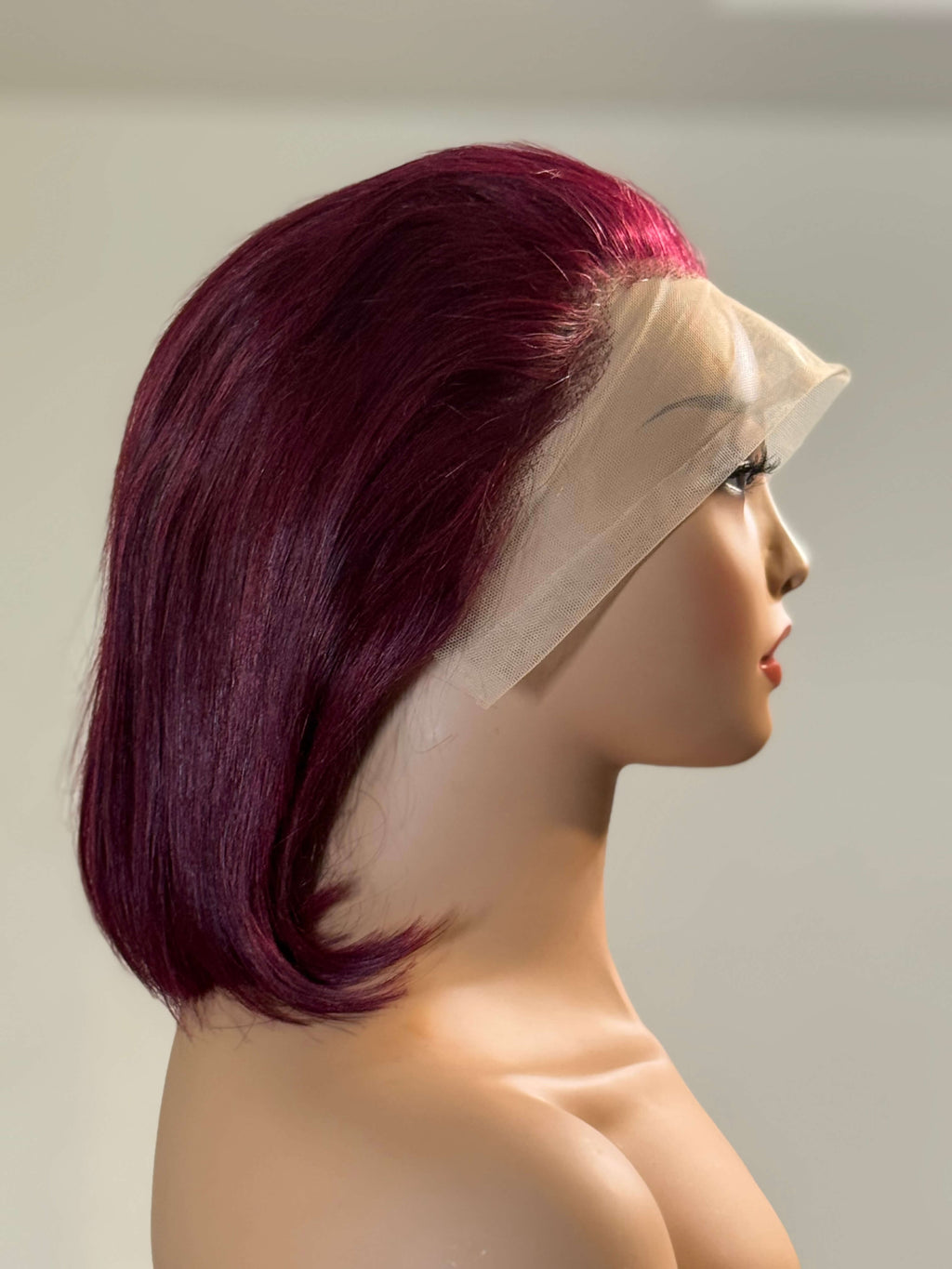 Mannequin head with a purple wig on a plain background. burgundy wig, burgundy red wig, burgundy lace front wig, burgundy human hair wig, wine red wig, wine color wig, red lace front wig, red human hair wig, red bob wig, burgundy bob wig, burgundy lace wig, burgundy human hair bob wig, straight bob wig, straight lace front wig, straight human hair wig, human hair bob wig, lace front bob wig, bob lace wig, chic bob wig, sleek bob wig, short human hair wig, short lace front wig, short wig, bob hairstyle wig