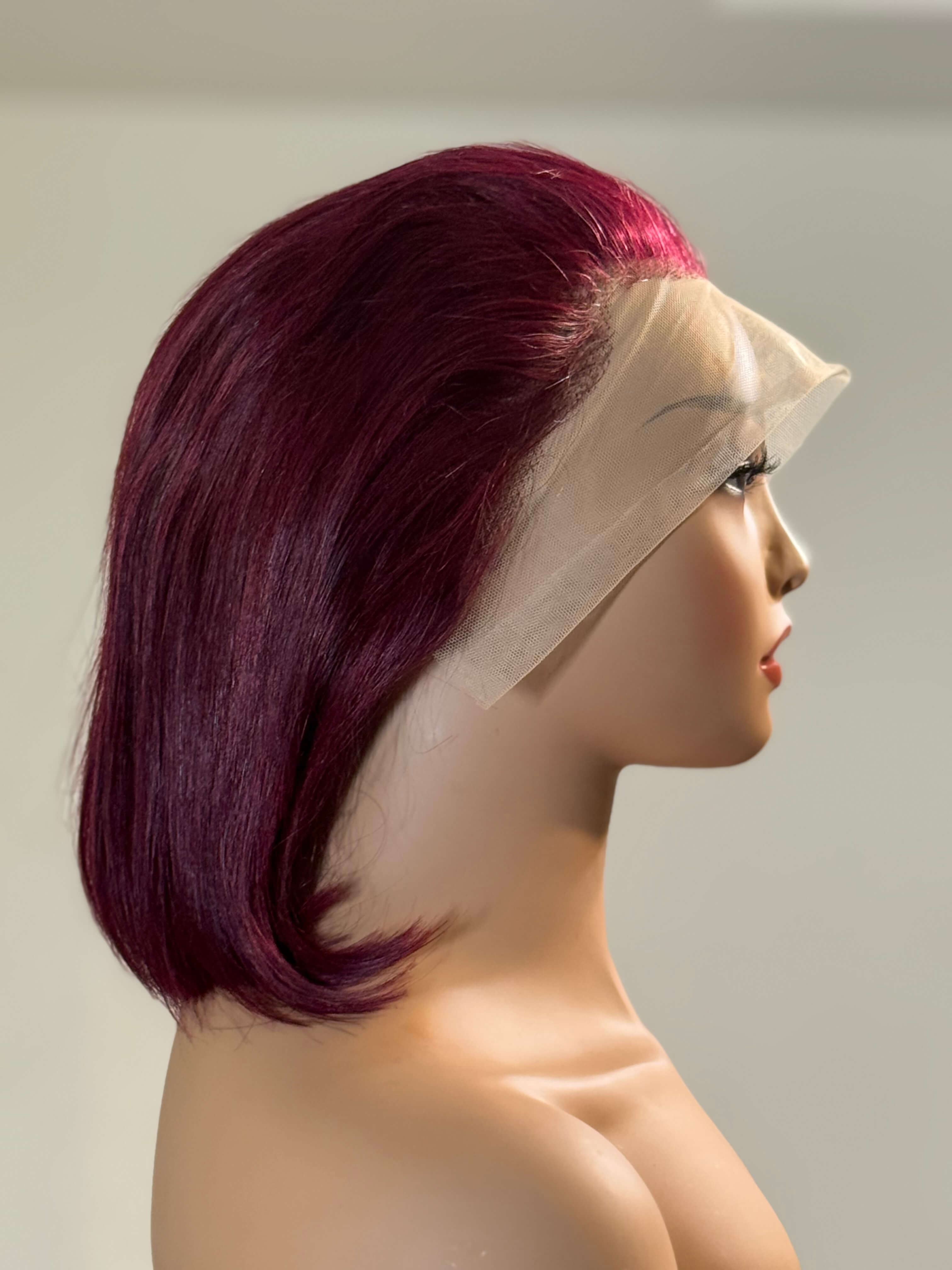 Mannequin head with a purple wig on a plain background. burgundy wig, burgundy red wig, burgundy lace front wig, burgundy human hair wig, wine red wig, wine color wig, red lace front wig, red human hair wig, red bob wig, burgundy bob wig, burgundy lace wig, burgundy human hair bob wig, straight bob wig, straight lace front wig, straight human hair wig, human hair bob wig, lace front bob wig, bob lace wig, chic bob wig, sleek bob wig, short human hair wig, short lace front wig, short wig, bob hairstyle wig