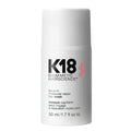 A white cylindrical bottle of K18 Biometric Hairscience leave-in molecular repair hair mask, featuring black and pink text on a clean white background.