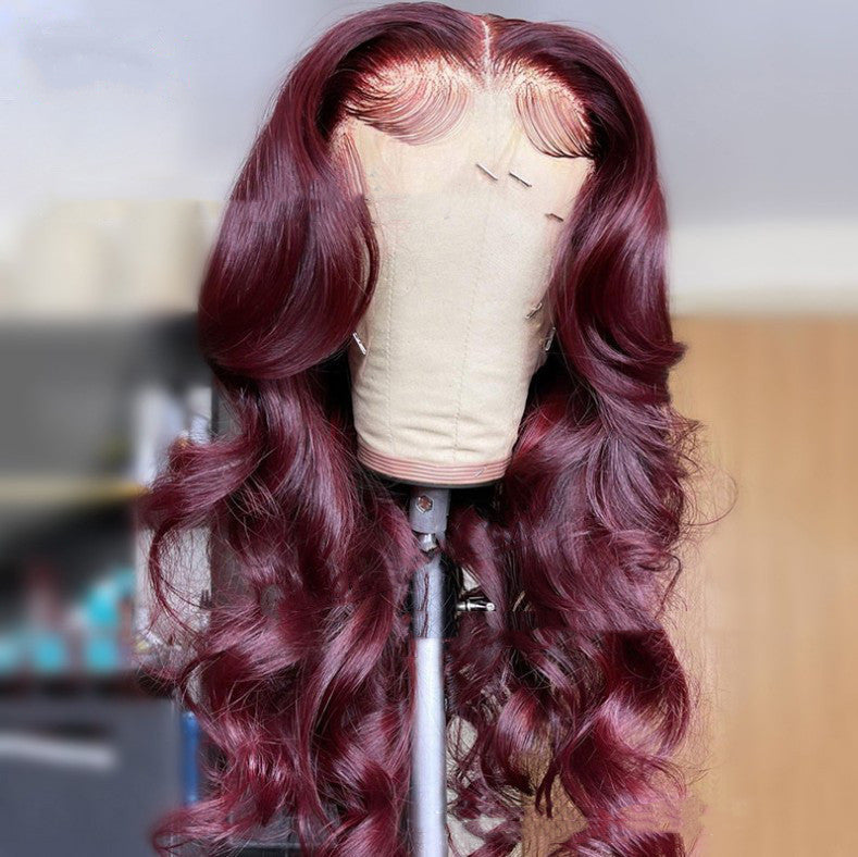 Red wig on a mannequin head with a blurred background. Wine Red Lace Front Wig – Long Curly Burgundy Synthetic Hair, Glamorous Natural Look