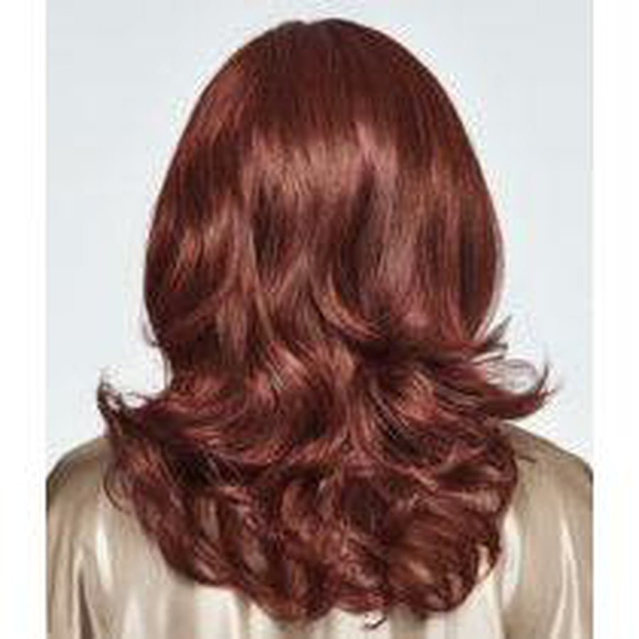 A medium-length wavy wig with a warm auburn reddish-brown color, shown from the back on a model wearing a light beige satin top against a light gray background.