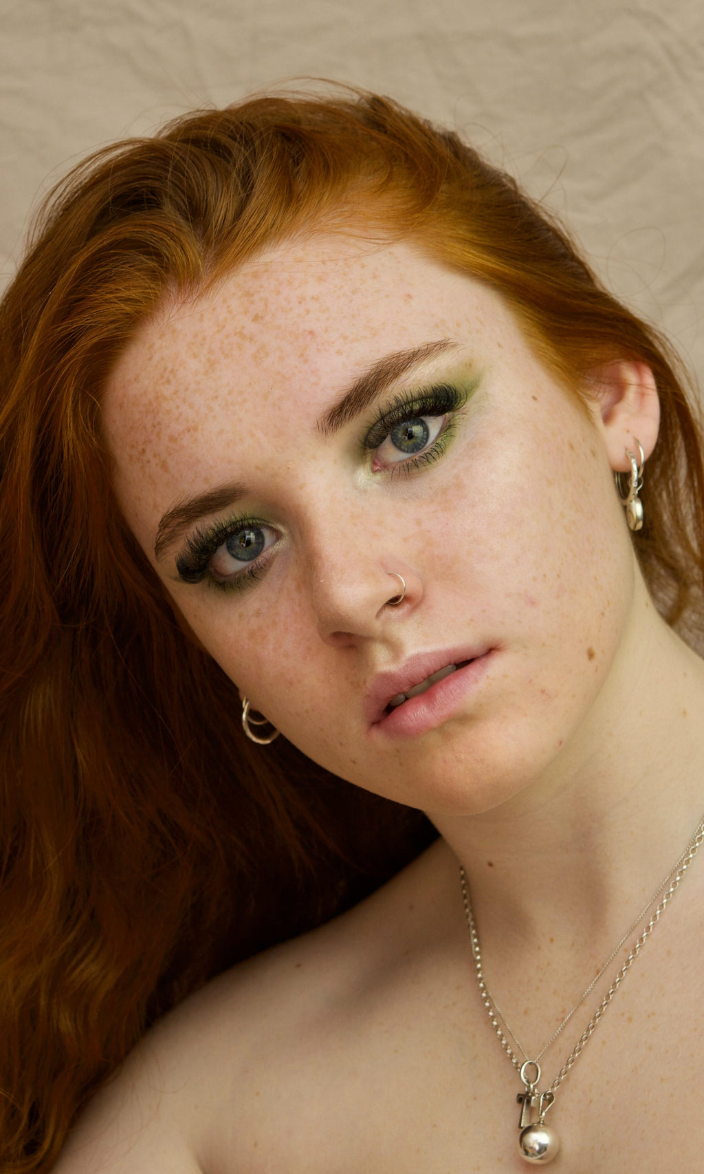 Danyel Cosmetics Eye Shadow model wearing bold green shimmer eyeshadow with dramatic lashes, showcasing highly pigmented, long-lasting, blendable, non-creasing professional eye makeup from Thai Luxury Hair.