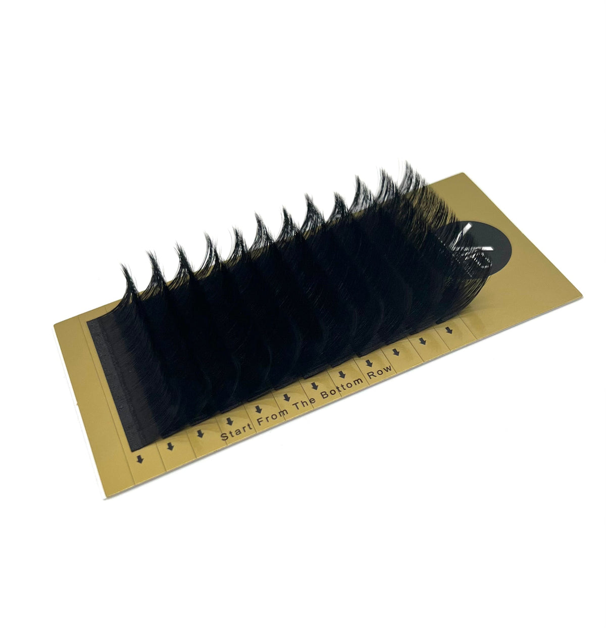 Set of false eyelashes on a cardboard holder with measurement scale.