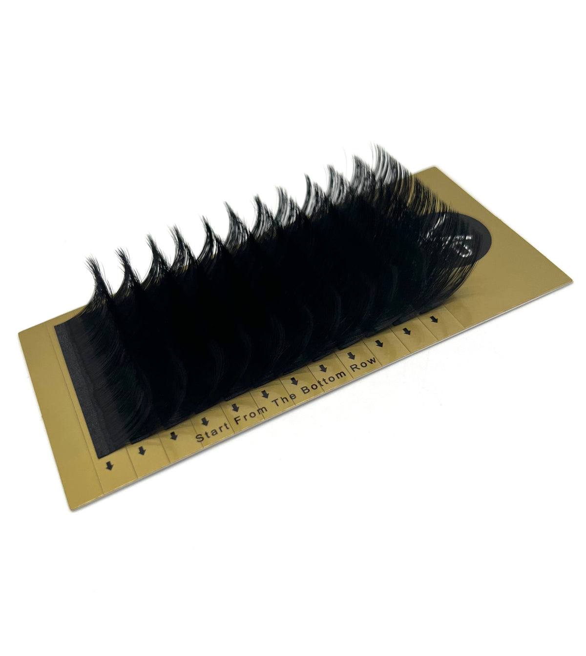 Set of false eyelashes on a gold card with measurement markings