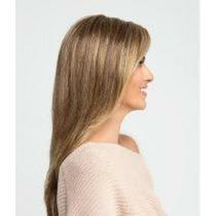 A woman shown in side profile wearing a long, straight wig with light brown and blonde highlights, paired with a light beige knit top against a plain light gray background.