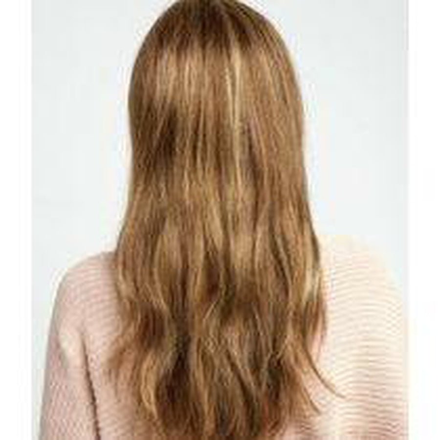 Long wavy light brown hair with subtle blonde highlights, shown from the back on a model wearing a pale pink ribbed sweater against a light gray background. Miles of Style - Wig by Raquel Welch