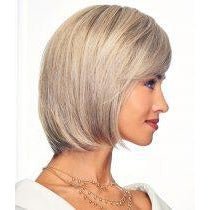 A woman shown in side profile wearing a short, layered bob wig with a warm ash blonde color and subtle gray highlights.