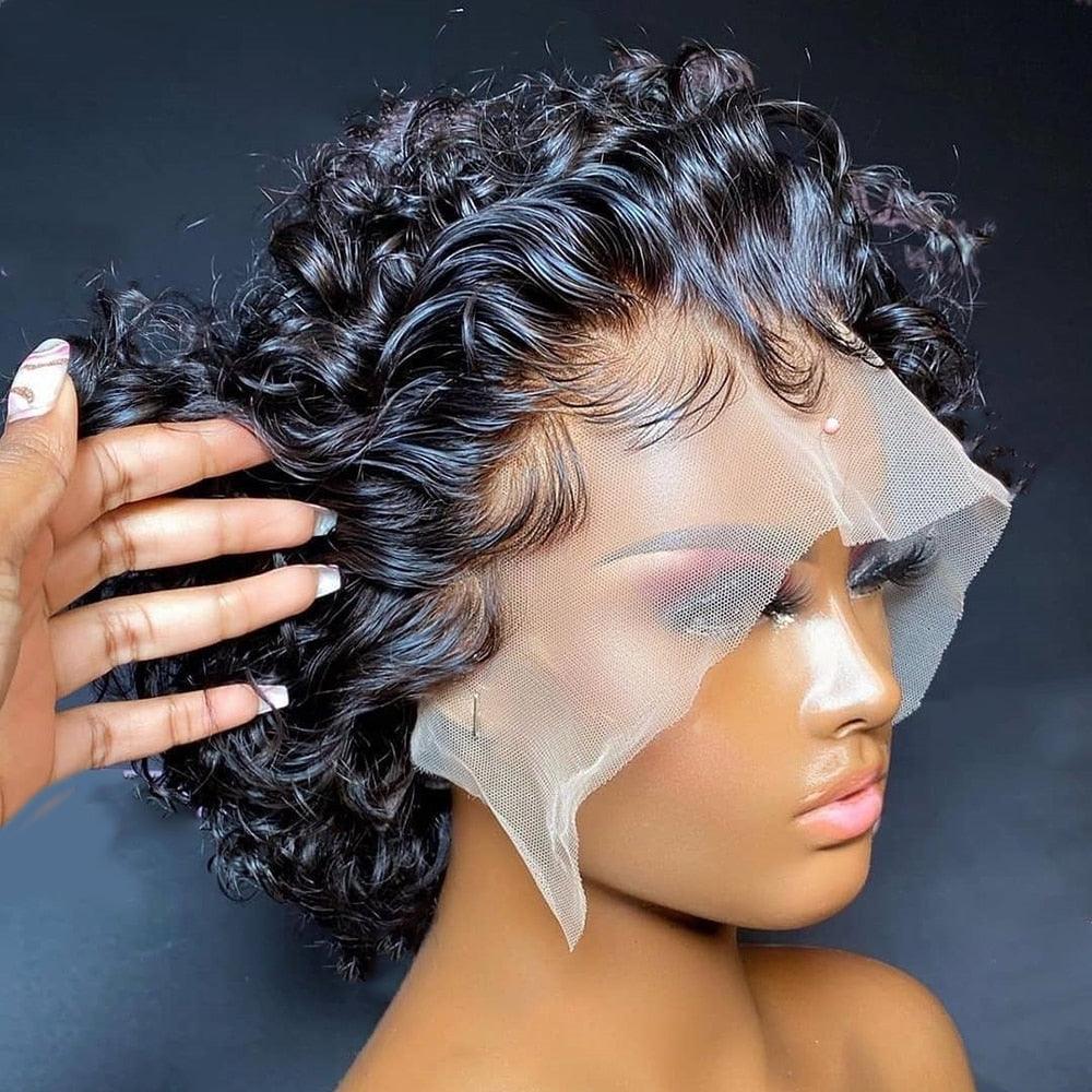 Person adjusting a black curly wig on a dark background