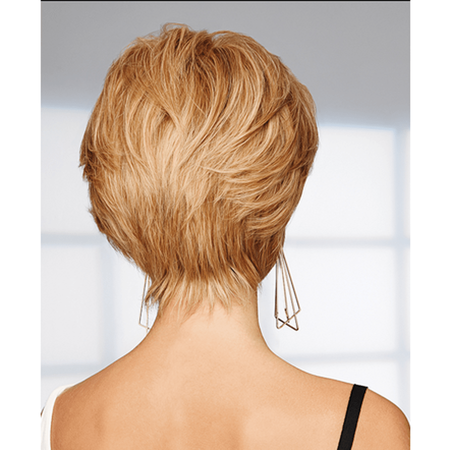 Back view of a person with a short layered pixie cut in warm blonde/light brown hair, wearing geometric dangling earrings and a black spaghetti strap top against a bright white window background.