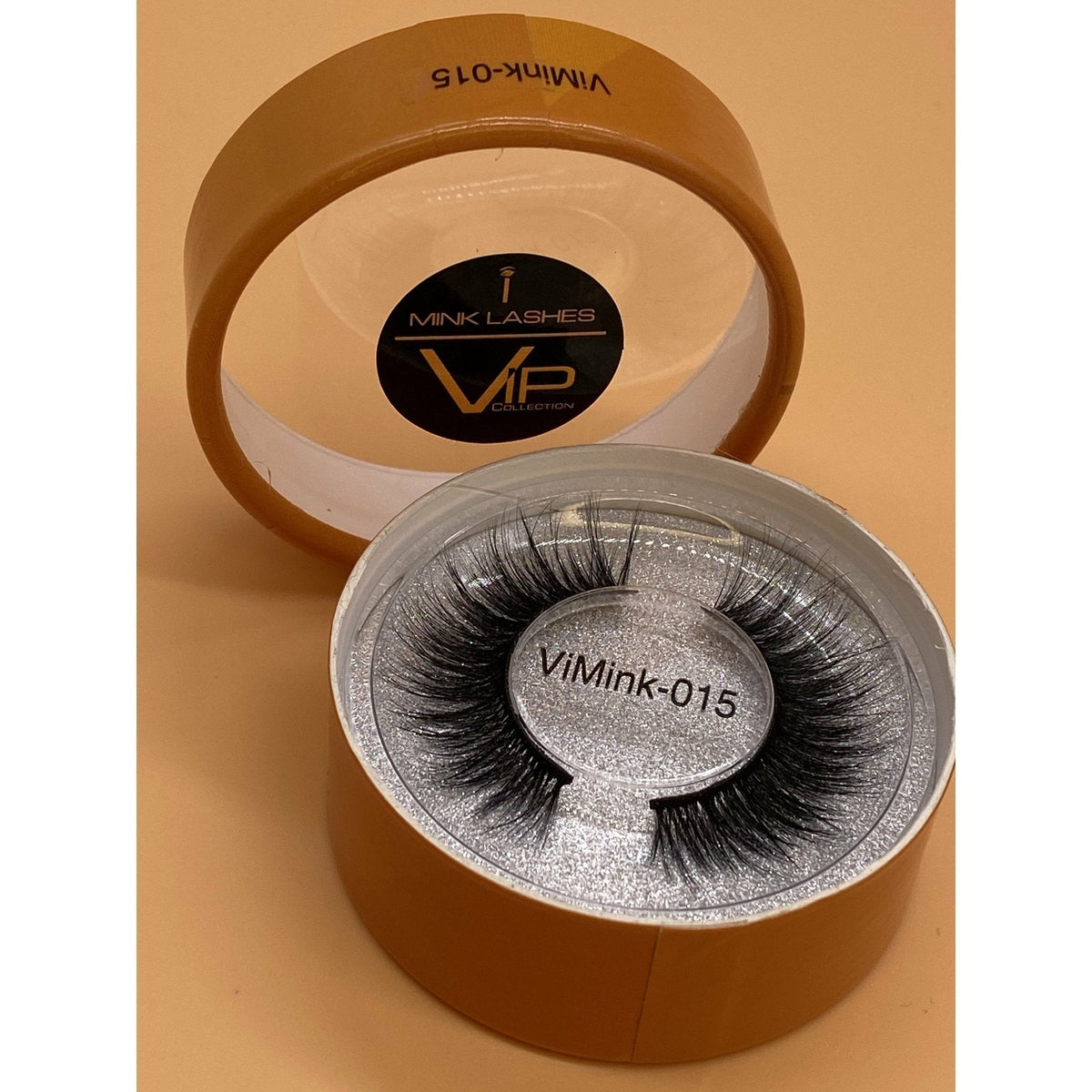 Elegant close-up of a pair of VIP iMink strip lashes displayed in high-quality packaging, showcasing the soft, voluminous texture and natural curl of the synthetic, animal-free fibers.